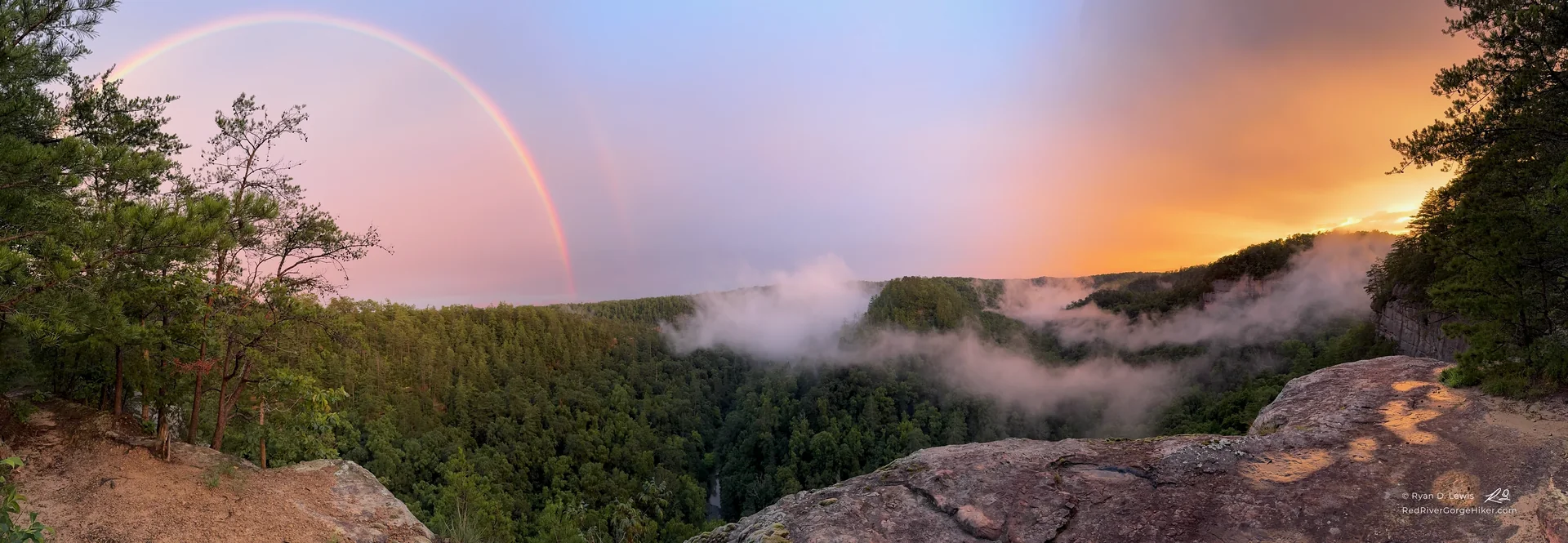 Double rainbow above foggy forested ridges, photographed from Eagle’s Point Buttress Overlook after a summer storm.