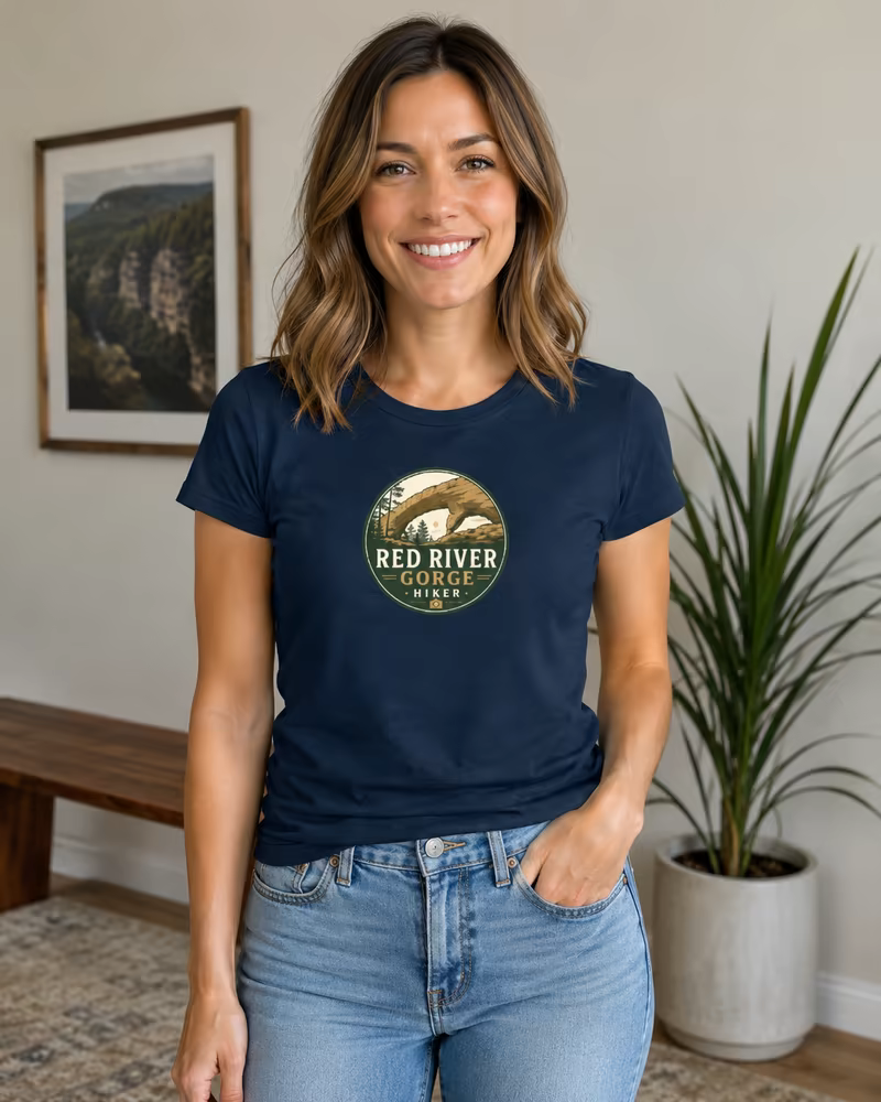 Woman wearing a navy Red River Gorge Hiker logo T-shirt with the logo centered on the chest.