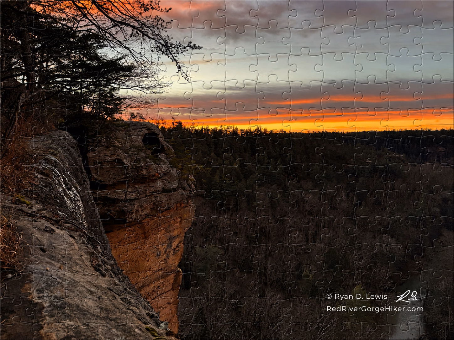 500-piece jigsaw puzzle showing Sunrise at Eagle’s Nest with a vivid winter sunrise and Red River Gorge Hiker artist mark.