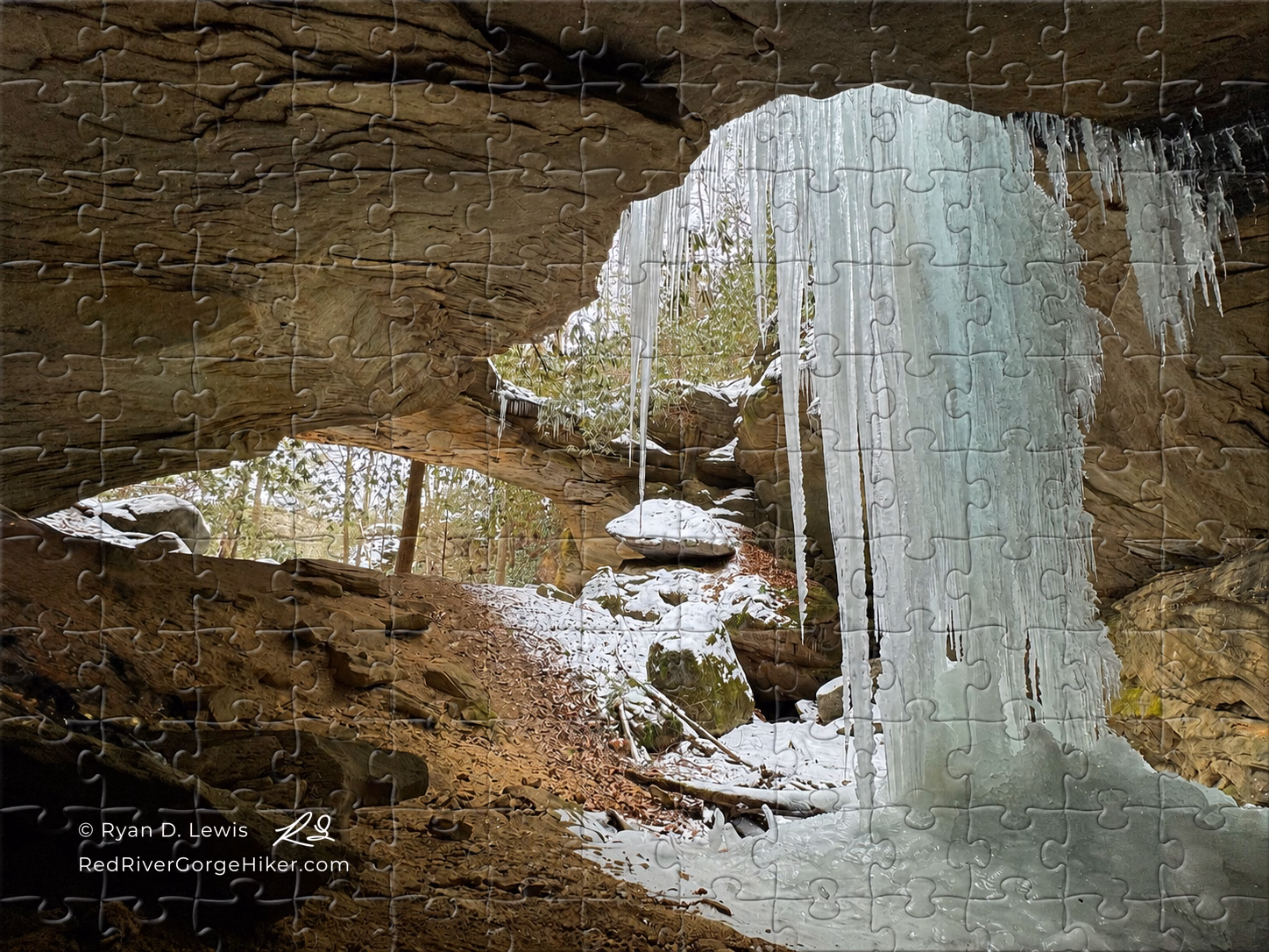 500-piece jigsaw puzzle showing Winter at Red-byrd Arch with the photographed ice formation and Red River Gorge Hiker artist mark.